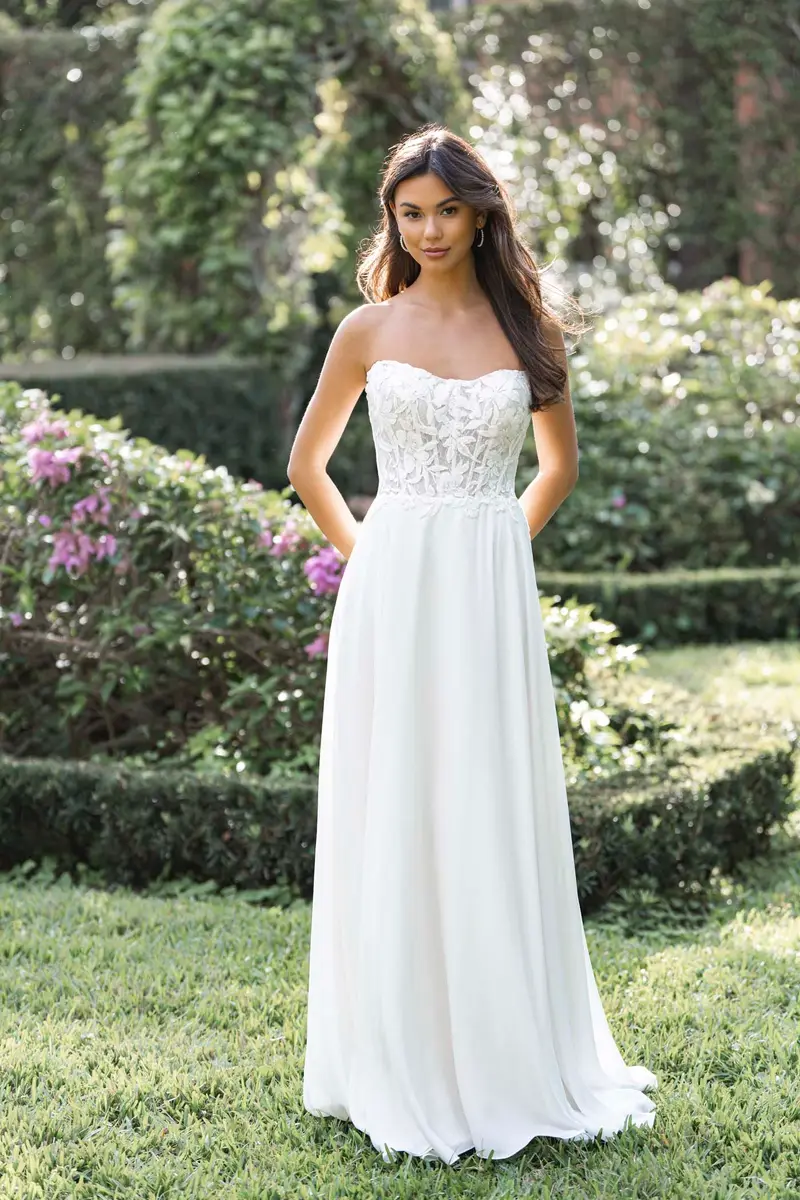 Romance style R3853 gown photographed in natural light at Cande Bridal Boutique, showing the ivory tone of the fabric