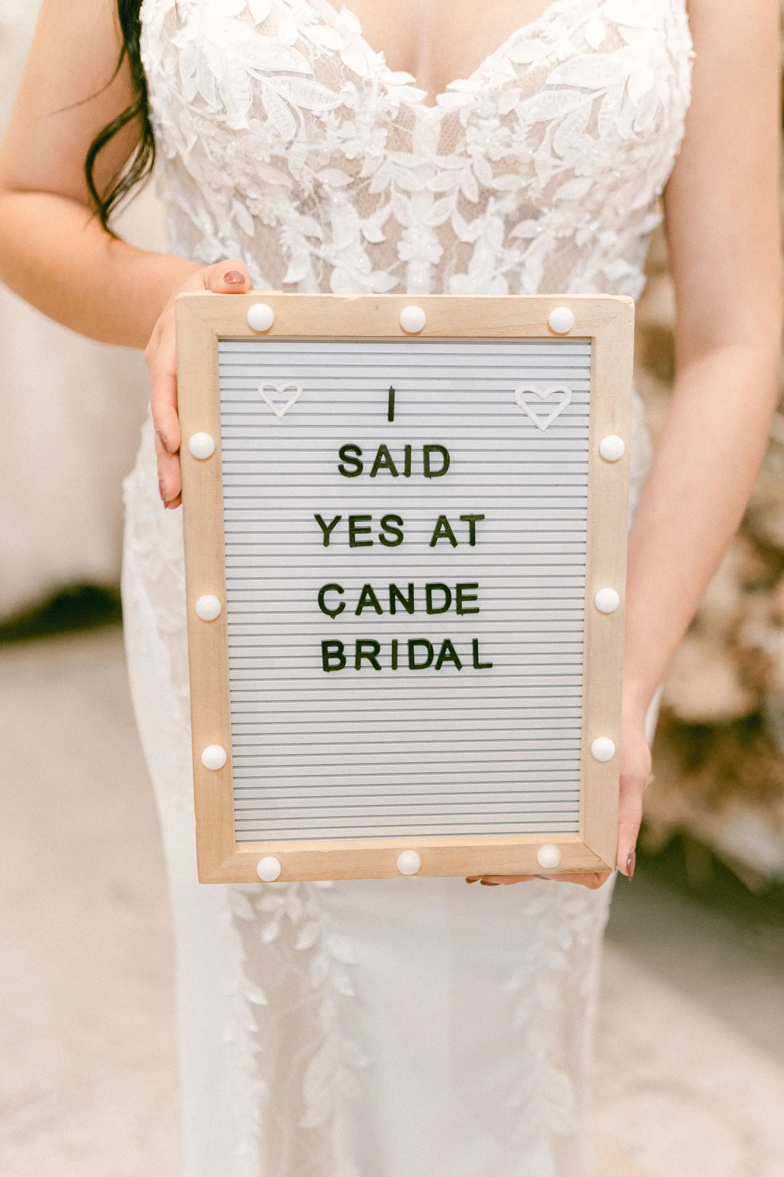 A bride standing full length in front of the mirror at Cande Bridal Boutique at the moment she chooses her gown